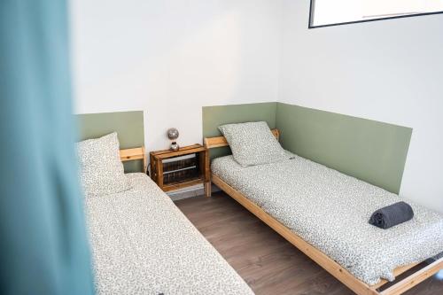 a room with two beds and a table at Grand appartement Familiale - Camargue in Salin-de-Giraud