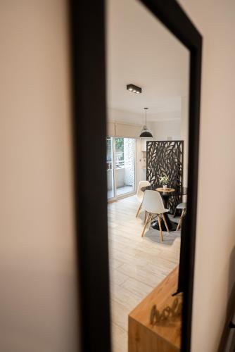 a mirror reflection of a living room with a table at Sucre Suites in Buenos Aires