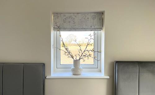 a window with a vase sitting on a window sill at Linwood in Lincoln