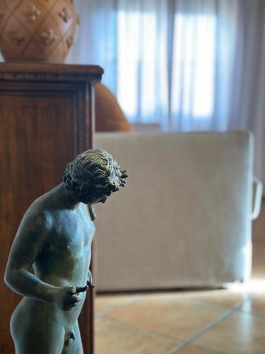 a statue of a woman standing in a room at Residence Internazionale in Pietrasanta