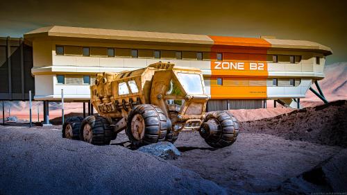 a dump truck parked in front of a building at Hôtel Station Cosmos in Chasseneuil-du-Poitou