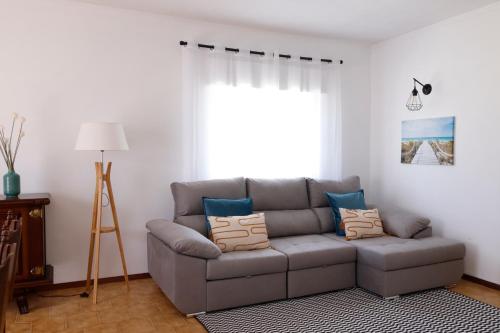 a living room with a couch and a window at *Private Outdoor Area* 300m-Beach, Swing/No Stairs in São Martinho do Porto