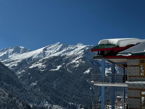 a ski lodge with a view of a mountain at Cafekush tosh in Tosh