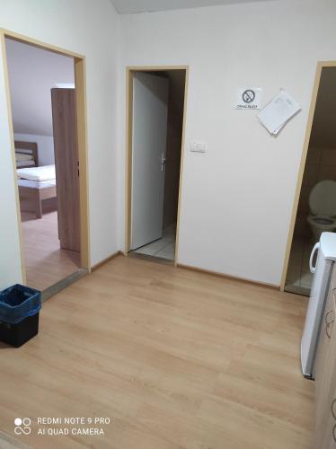 an empty room with a mirror and a door at Penzión Enbra 
