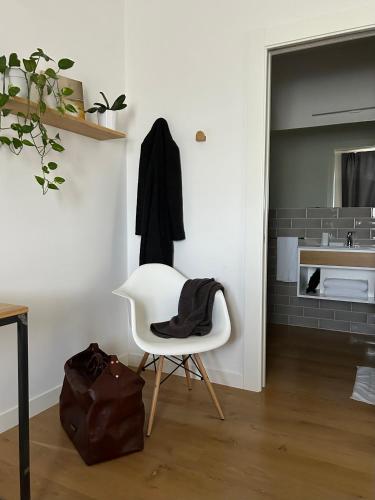 a white room with a white chair and a sink at Casale Appia in Latina