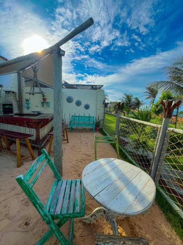 a table and two chairs and a table and a table and bench at ASAS DEL MAR - SUITES in Canoa Quebrada
