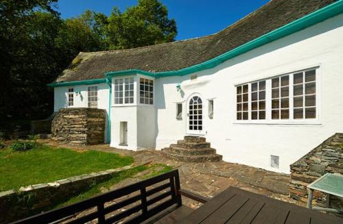 a white house with a fence in front of it at Portmeirion Village & Castell Deudraeth in Porthmadog
