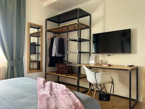 a bedroom with a bed and a desk with a television at Casale Appia in Latina