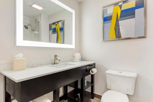 a bathroom with a sink and a toilet at Comfort Inn & Suites Irving Las Colinas DFW in Irving