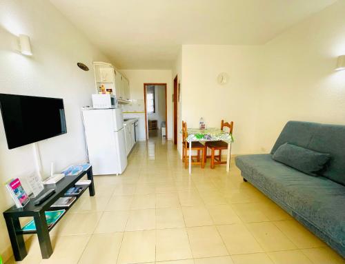 a living room with a couch and a table at Sunlight apartment in Costa de Antigua in Costa de Antigua