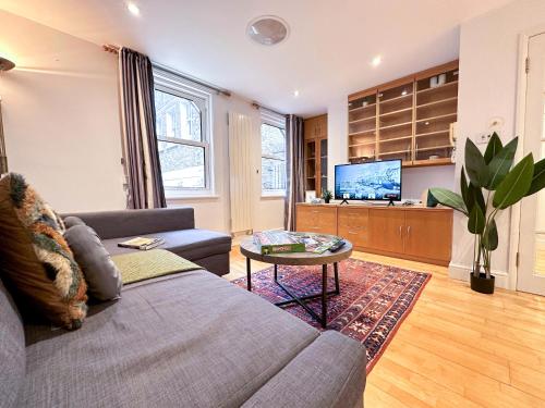 a living room with a couch and a table at Stunning Houses with FREE PARKING in Little Venice with Canal view in London