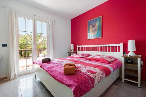 a red bedroom with a bed with a teddy bear on it at Very well maintained house in Chayofa, the sunny south of Tenerife in Chayofa