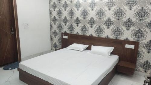 a bed with two pillows in a bedroom at Hotel Kadamb, Palwal in Palwal