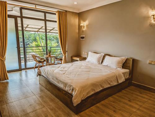 1 dormitorio con 1 cama grande y 1 mesa en Funky Moon Kampot en Kampot