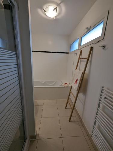 a bathroom with a ladder and a window in it at Les Terrasses De Vignola in Porto-Vecchio