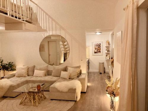 a living room with a couch and a mirror at AMALFI HOME - Stylish apartment with terrace in Schönefeld