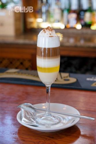 a dessert in a glass on a plate on a table at THE CLUB - Accommodation - Dining - Events in San Miguel de Abona