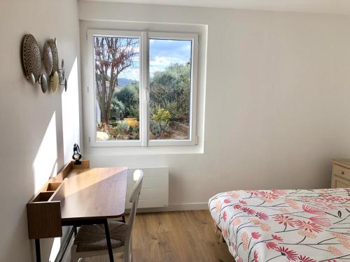 une chambre avec un lit, un bureau et une fenêtre dans l'établissement La rocaille du château, à Gréoux-les-Bains