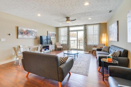 a living room with couches and a tv at Downtown St Joseph Condo with Balcony and Harbor View in Saint Joseph