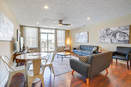 a living room with a table and chairs at Downtown St Joseph Condo with Balcony and Harbor View in Saint Joseph