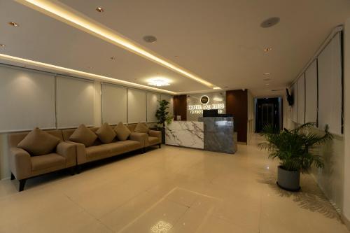 a lobby with couches and a counter in a building at Sai Bliss International, Bangalore in Bangalore