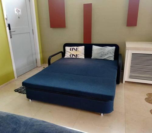 una cama azul con almohadas en una habitación en Port Dickson Leisure Water Villa, en Port Dickson