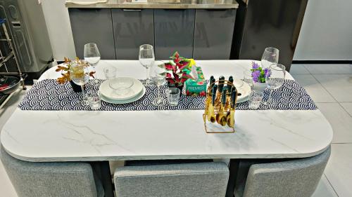 a white table with a blue and white table cloth at Apartment in Georgetown 3BR-10pax in Jelutong