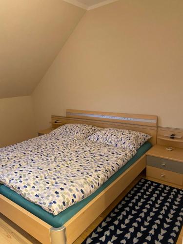 - une chambre avec un lit et un tapis dans l'établissement Ferienwohnung Weberschläger, à Ulrichsberg