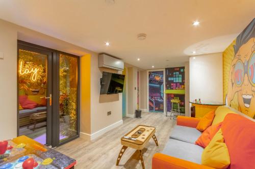 a living room with a couch and a table at The Old School House - Luxury Themed Apartments in Nottingham