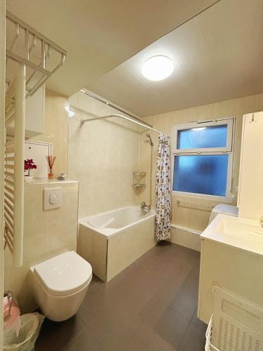 une salle de bain avec toilettes, baignoire et lavabo dans l'établissement Fillettes-Stade de France-Parking, à Aubervilliers