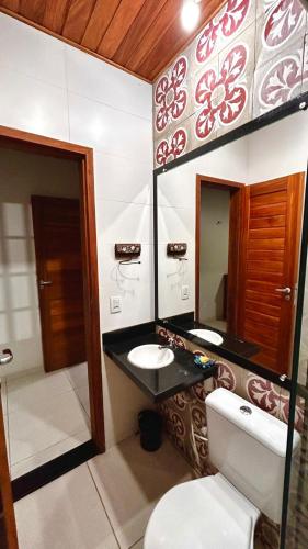 a bathroom with two sinks and a mirror at Casa Pierot in Luis Correia