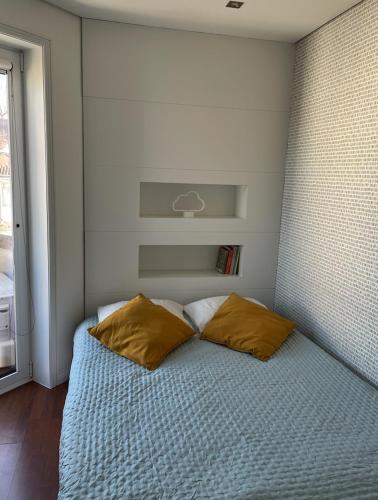 a bedroom with a bed with two pillows on it at Apartament Praceta Vila do Conde in Vila do Conde