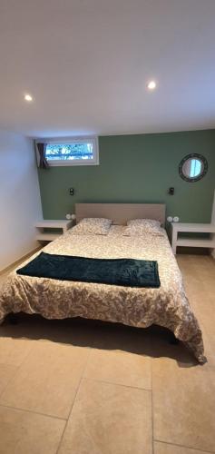 a bedroom with a bed and a window in it at La romarine in Bourg-Saint-Andéol