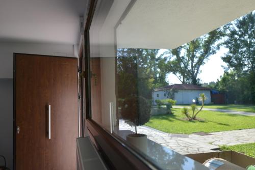an office window with a view of a yard at Theros-Cottage in Siviri