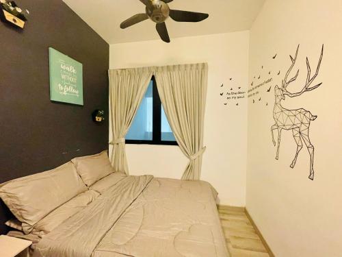 a bedroom with a bed with a deer decal on the wall at MidValley SouthKey Mosaic Tower B in Johor Bahru