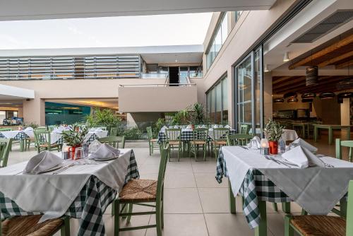 a restaurant with two tables and chairs and tablesktop at Atlantica Mikri Poli Kos in Kardamaina