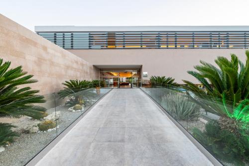 an external view of a building with a walkway at Atlantica Mikri Poli Kos in Kardamaina