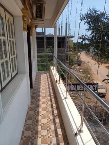 a balcony of a house with a walkway at Guru Residency Pondicherry in Puducherry