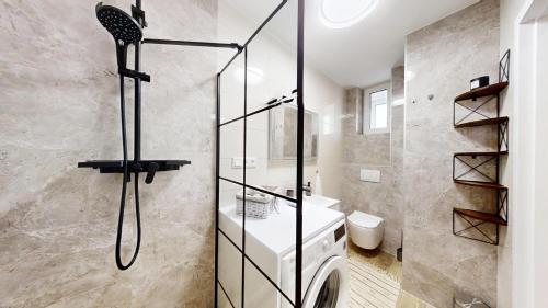 a bathroom with a shower and a sink at Ambient apartment in Žilina