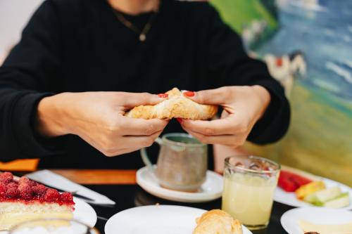 a person holding a piece of food in their hands at Hostal Concepcion in Concepción