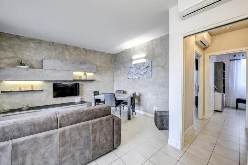 a living room with a couch and a table at Maison Martina in Lonato del Garda