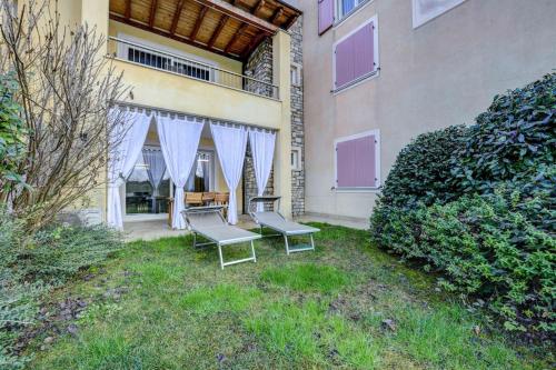 two chairs and a table in the yard of a building at Maison Martina in Lonato del Garda