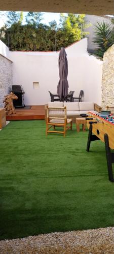 een tuin met een bank en een tafel en stoelen bij Le 41 bis in Aigues-Mortes
