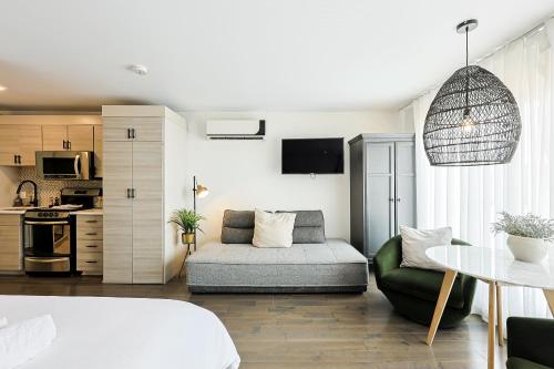 a living room with a couch and a table at Les Lofts du Lac des Sables by Gestion ELITE in Sainte-Agathe-des-Monts