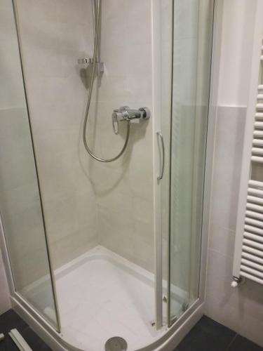 a shower in a bathroom with a glass door at Romeo Design Rooms in Verona