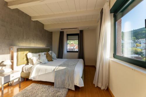 a bedroom with a bed and a large window at Hotel San Giorgio in Vis
