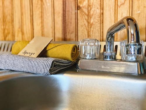 a kitchen sink with towels and a faucet at Flathead Lake Resort in Bigfork
