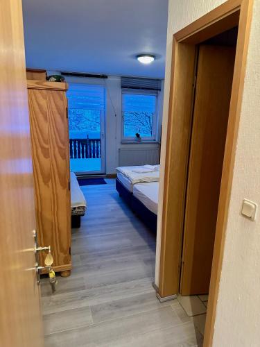 a room with two beds and two windows at Pension Raststüb'l in Sorge