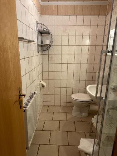a bathroom with a toilet and a sink at Pension Raststüb'l in Sorge