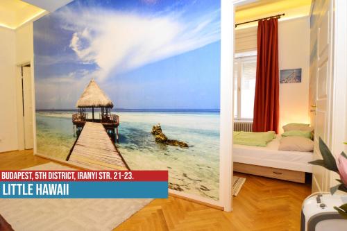 a room with a wall mural of a pier on the beach at Little Americas Downtown Apartments in Budapest